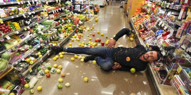 Person slipping on wet grocery store floor.