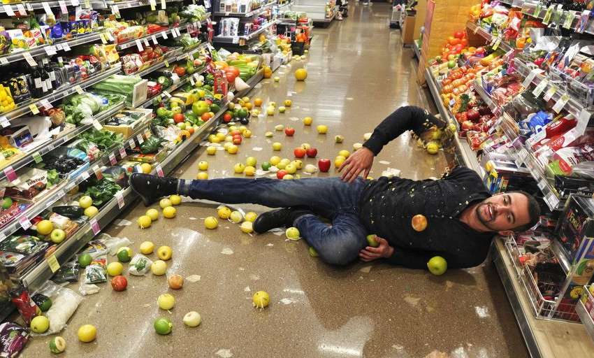 Person slipping on wet grocery store floor.