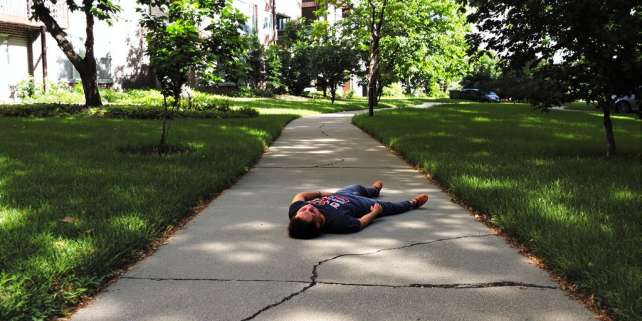 Person falling on apartment complex walkway.