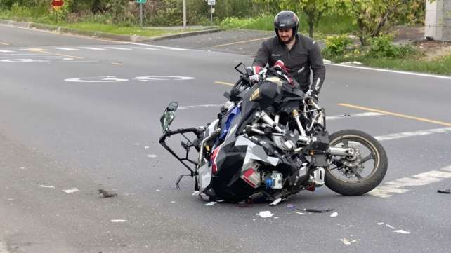 Motorcycle accident aftermath on a road.