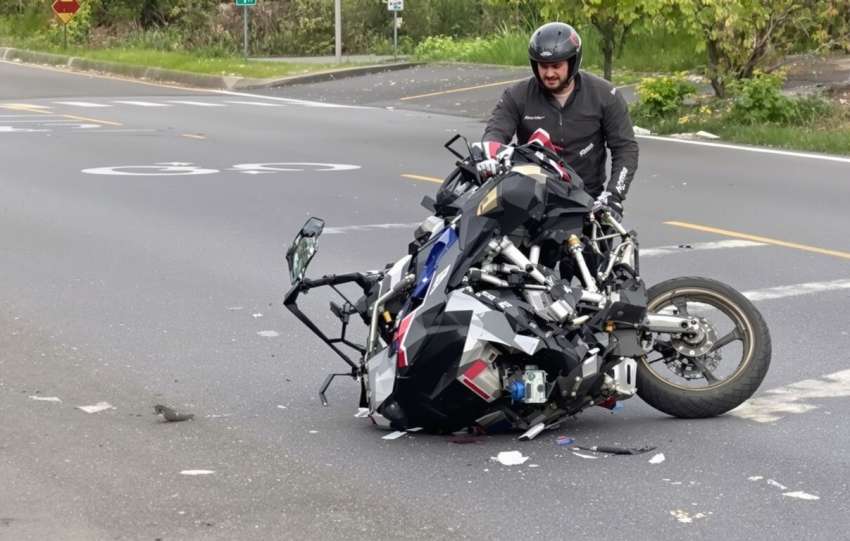 Motorcycle accident aftermath on a road.