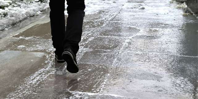Person on a wet sidewalk after a fall.