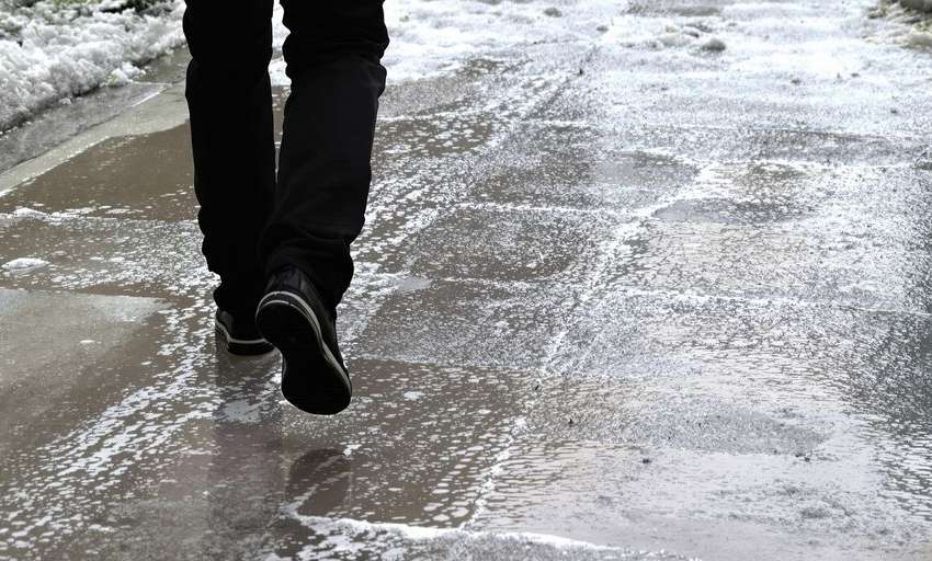 Person on a wet sidewalk after a fall.