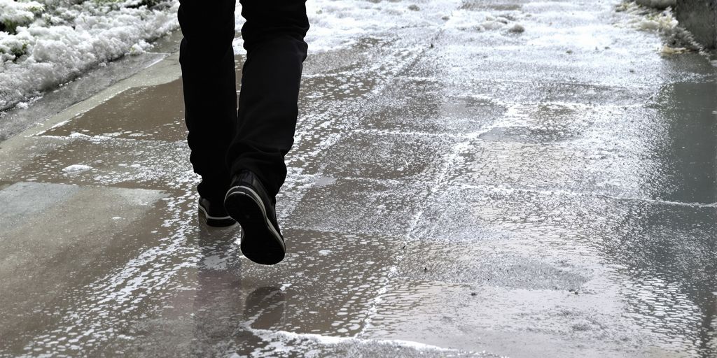 Person on a wet sidewalk after a fall.