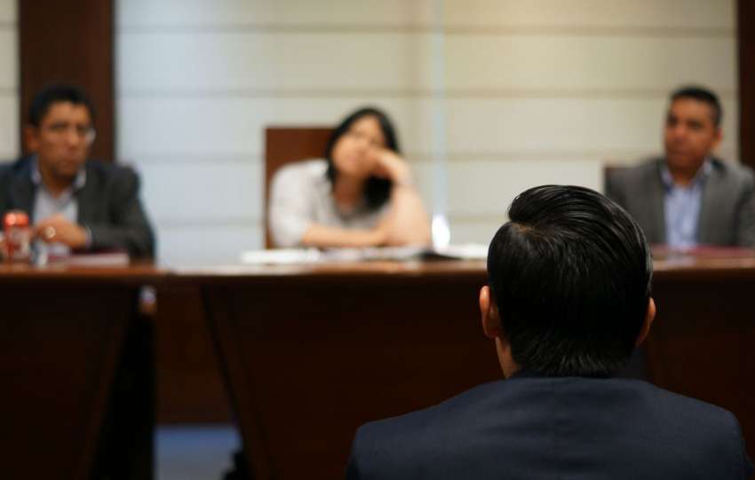 man in black shirt sitting beside woman in white shirt
