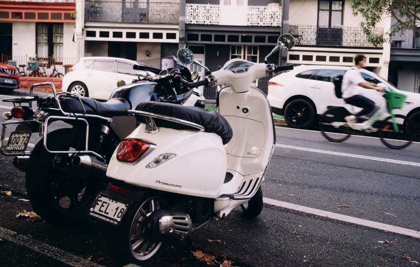 Motorbikes and scooters parked on a city street.