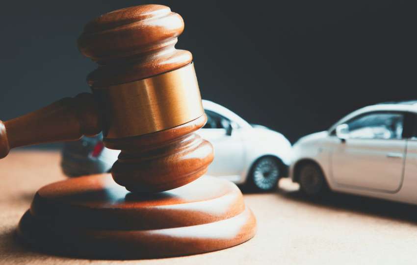 a toy car and a wooden gaven on a table