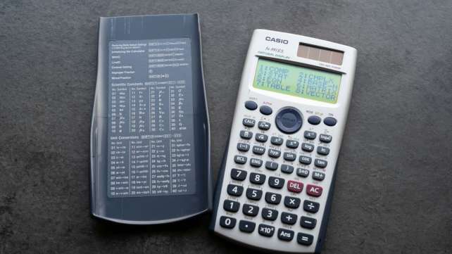 A scientific calculator with its cover open